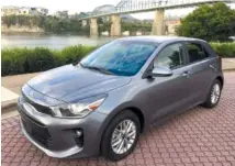  ?? STAFF PHOTO BY MARK KENNEDY ?? The 2018 Kia Rio 5-Door EX has been redesigned inside and out. Black leather interior with red inserts is a $500 option on the Rio. The rear of the the Kia Rio hatchback offers a lower lift-over height than previous models.