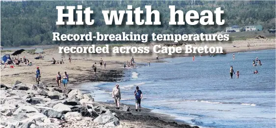  ?? NICOLE SULLIVAN/CAPE BRETON POST ?? Beachgoers enjoy a walk along Dominion beach on June 19, while other dip into the cool ocean during the second day of a heat wave which saw temperatur­e to 38 C with humidex at 3 p.m. The beach was scarcely filled with people, unlike hot days in the past and there were signs on washrooms reminding people of social distancing protocols required in Nova Scotia while in recovery from the COVID-19 outbreak.