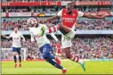  ?? ?? Arsenal's Portuguese defender Nuno Tavares (R) crosses the ball during the match