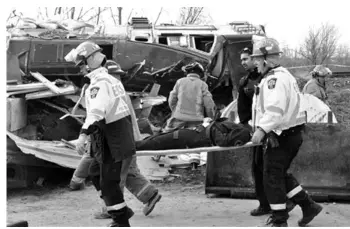  ??  ?? Emergency crews work the scene of a Via Rail train derailment in Burlington, Ontario, west of Toronto. ASSOCIATED PRESS