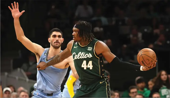  ?? MA. NANCY LANE — BOSTON HERALD ?? Boston Celtics center Robert Williams III looks to pass around Memphis Grizzlies forward Santi Aldama during the fourth period of the game at the TD Garden on Sunday,February 12, 2023 in Boston,