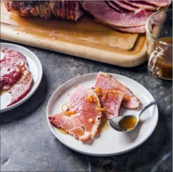  ?? JOE KELLER — AMERICA’S TEST KITCHEN VIA AP ?? This undated photo provided by America’s Test Kitchen in October 2018 shows glazed spiral-sliced ham in Brookline, Mass. This recipe appears in the cookbook “All-Time Best Holiday Entertaini­ng.”