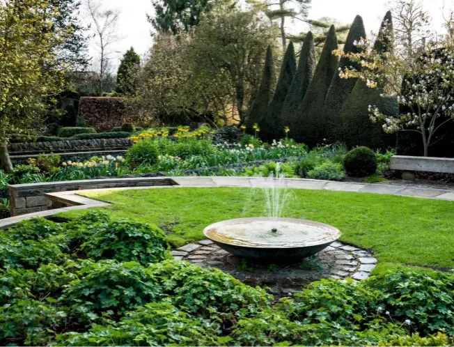  ??  ?? Sybil’s garden, previously a vegetable patch, is based on a series of circles, including a sweep of box hedge and a central fountain. ›