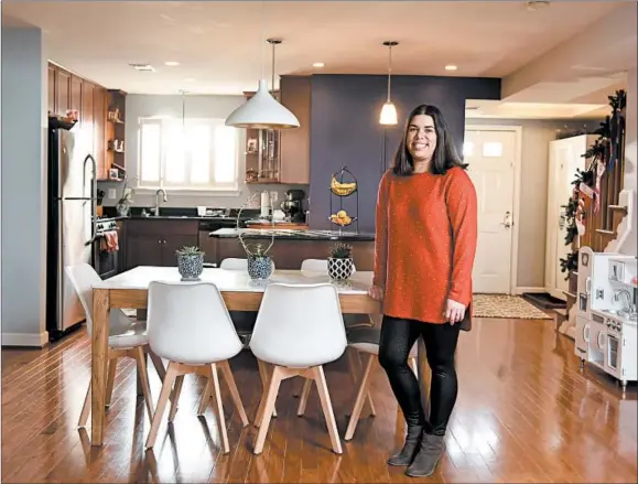 ?? MARVIN JOSEPH/WASHINGTON POST ?? Eliana Kee stands near her kitchen in Arlington, Virginia. She and her husband, Brian, liked that the home, which they purchased for $515,000, was move-in ready.