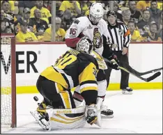  ??  ?? Penguins goalie Matt Murray makes a first-period save as Senators winger Clarke MacArthur looks for the puck during Thursday night’s Eastern Conference Game 7.