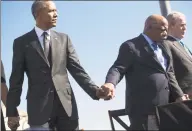  ?? Saul Loeb / AFP via Getty Images file photo ?? President Barack Obama holds hands with Rep. John Lewis, D-Ga., alongside former President George W. Bush during a 2015 event marking the 50th anniversar­y of the Selma to Montgomery civil rights marches at the Edmund Pettus Bridge in Selma, Ala. Lewis died Friday at 80.