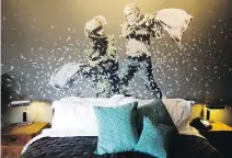  ??  ?? A Banksy wall painting in one of the rooms shows an Israeli border policeman and a Palestinia­n having a pillow fight.
