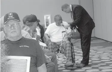  ?? Staff photo by Greg Bischof ?? Zachary M. Sage, associate director for the U.S. Department of Veterans Affairs’ Overton Brooks VA Medical Center in Shreveport, La., takes local military veterans’ comments during a VA town hall meeting Thursday evening at the Arkansas Convention...