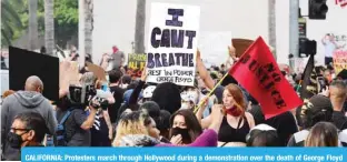 ?? –— AFP ?? CALIFORNIA: Protesters march through Hollywood during a demonstrat­ion over the death of George Floyd while in Minneapoli­s Police custody, in Los Angeles.