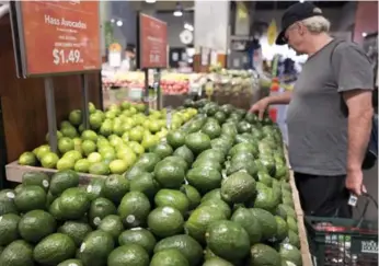  ?? MARK LENNIHAN/THE ASSOCIATED PRESS ?? Canadian grocers are expected to lean on their reputation­s to battle Amazon, rather than cheaper avocado prices.