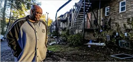  ?? JOHN SPINK/JOHN.SPINK@AJC.COM ?? Rodney Blalock, who has lived at the Shepard’s Walk apartment complex for nine months, looks over what remained after a fire tore through eight units Tuesday. The complex, located along Osborne Road near Marietta, is run by MUST Ministries.