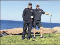  ??  ?? Abdul Rafih, left and Ken Atkinson take a break during a round of golf at Fox Harbour.