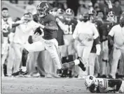  ?? Getty Images ?? ALABAMA’S DeVonta Smith, running past an Auburn defender, scored on two long passes.