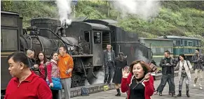  ?? GETTY IMAGES ?? People prepare to board a ‘‘slow train’’ in Bagou, Sichuan Province, southern China. The trains are a lifeline for many isolated villages.