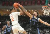  ?? (AP photo/Marta Lavandier) ?? Miami guard Isaiah Wong (2) attempts to score as Duke center Dereck Lively II (1) defends Monday during a college basketball game in Coral Gables, Fla.