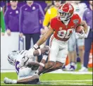  ?? Butch Dill The Associated Press ?? Alabama wide receiver Kobe Prentice eludes Kansas State safety V.J. Payne on a 47-yard TD catch during the Crimson Tide’s 45-20 victory Saturday.