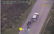  ?? Associated Press ?? A police video shows Terence Crutcher (top) being pursued by police officers as he walk to his SUV.