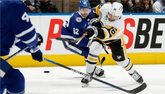  ?? Bruce Bennett/Getty Images ?? The Penguins’ Jason Zucker takes the first period shot Friday against the Toronto Maple Leafs at the Scotiabank Arena in Toronto.
