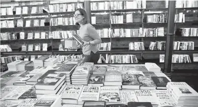  ??  ?? Part owner Mary Mollman at the Madison Street Books store on March 20, 2020, in Chicago.