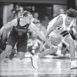  ?? Timothy J. Gonzalez Associated Press ?? USC’s JORDAN McLAUGHLIN knocks the ball away from Oregon State’s Ethan Thompson in the second half. McLaughlin had 12 points and six assists.