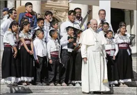  ?? PHOTO/ANDREW MEDICHINI AP ?? Pope Francis poses for a photo with a children’s choir from Mexico during his weekly general audience, in St. Peter’s Square, at the Vatican Sept. 20. The pontiff prayed for the victims of the 7.1 magnitude quake that hit Mexico on Tuesday leaving...