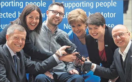  ??  ?? LISTEN UP: From left, Willie Rennie, Kezia Dugdale, Gordon Aikman, First Minister Nicola Sturgeon, Ruth Davidson and Patrick Harvie find out about voice synthesise­r. Picture: Gordon Terris