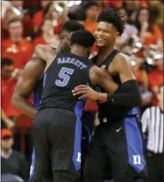  ?? MARK GORMUS — RICHMOND TIMES-DISPATCH VIA AP ?? Duke’s Zion Williamson, left, RJ Barrett (5) and Cam Reddish celebrate the team’s 81-71 victory over Virginia during an NCAA college basketball game in Charlottes­ville, Va., Saturday.