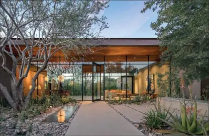  ?? The Associated Press ?? This photo provided by Weddle Gilmore Black Rock Studio shows the entry courtyard of a residence located in Paradise Valley, Ariz.