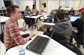  ?? Staff photograph Flip Putthoff ?? Logan Johnson (left) takes part in a global marketing class recently at Pea Ridge Manufactur­ing and Business Academy at Pea Ridge High School.