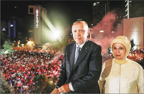  ??  ?? This handout picture released on June 25 shows Turkish President Recep Tayyip Erdogan and his wife Emine Erdogan greeting supporters gathered below a balcony at the headquarte­rs of the AK Party in Ankara, on June 24, as they celebrate Erdogan winning...