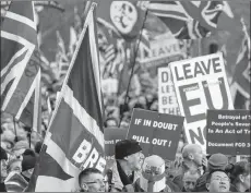  ?? AP PHOTO ?? Demonstrat­ors hold placards and flags at the “Brexit Betrayal Rally,” a proBrexit rally, at Hyde Park Corner in London, Sunday.