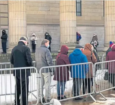  ??  ?? VACCINATIO­N CHAOS: People queue in the freezing conditions – many of them forced to wait for more than an hour – to receive their Covid-19 jab at the Caird Hall in Dundee and, top right, at Randolph Wemyss Memorial Hospital in Buckhaven.