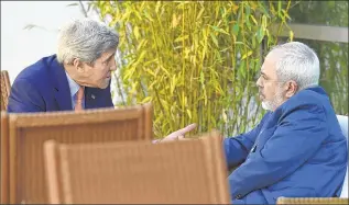  ??  ?? ASSOCIATED PRESS U.S. Secretary of State John Kerry (left) talks with Iranian Foreign Minister Mohammad Javad Zarif Saturday in Geneva, Switzerlan­d, hoping to bridge difference­s over a nuclear inspection accord.