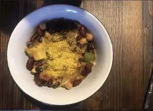  ??  ?? Try variations on black bean chili with different seasonal vegetables, like this chili using squash and zucchini topped with nutritiona­l yeast.