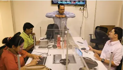  ?? — AFP FILE ?? BOOM’S managing editor Jency Jacob (centre) interacts with staff at BOOM Live office in Mumbai. India has the world’s largest number of certified factchecki­ng organisati­ons, BOOM Live is among those that methodical­ly debunk some of the tsunami of internet falsehoods, but their efforts can feel like a drop in the bucket.