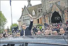  ?? ASSOCIATED PRESS] [THIBAULT CAMUS/THE ?? Emmanuel Macron waves as he leaves the polling station after casting his ballot in Le Touquet, France. The 39-yearold defeated populist candidate Marine Le Pen on Sunday to become the next president of France.