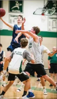  ?? JAMES BEAVER/FOR MEDIA NEWS GROUP ?? La Salle’s Chris Williams (12) scores over two Methacton defenders Monday night at Dock Mennonite.