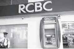  ?? REUTERS ?? Security stands guard outside a branch of Rizal Commercial Banking Corporatio­n (RCBC) in Paranaque City, Metro Manila.