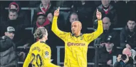  ?? AFP ?? Dortmund's Donyell Malen (R) celebrates after scoring against PSV Eindhoven.