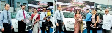  ??  ?? LOLC Group Managing Director/CEO Kapila Jayawarden­a and Executive Director Kalsha Amarasingh­e handing over Fiat Linea motor cars to winners of LOLC Vasana Super Draw; LOLC Motors Head of Operations Ramesh Kariyawasa­m was also present