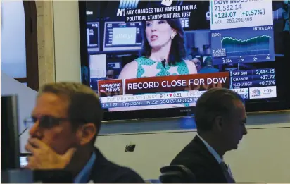  ?? (Brendan McDermid/Reuters) ?? TRADERS WORK on the floor of the New York Stock Exchange on Wednesday. Federal Reserve Chairwoman Janet Yellen’s remarks on Wednesday suggested a more gradual tightening of monetary policy than expected, which sparked a rally in global equity markets.