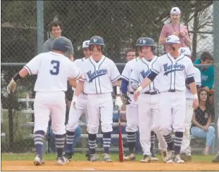  ??  ?? La Plata’s Tyler Stockwell is greeted by teammates after his solo homer in the second inning of the Warriors’ 11-1 win over the visiting Huntingtow­n Hurricanes on Thursday afternoon.
