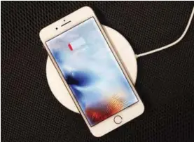 ?? — AP ?? NEW YORK: iPhone 8 Plus rests on a wireless charger in New York.