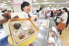  ??  ?? This photo shows chocolates for sale at a floor prepared specially for Valentine’s Day gifts at a department store in Tokyo. Japanese women have been crowding department stores to scoop up chocolates for their male coworkers in a ritual of obligation...
