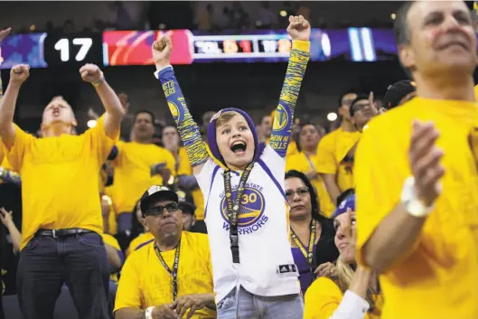  ?? Santiago Mejia / The Chronicle 2017 ?? Jack Covin, age 12, wears a Stephen Curry jersey as he cheers the Warriors against Cleveland in the 2017 NBA Finals at Oracle Arena.