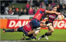  ?? Photo / Photosport ?? Josh McKay struggles to escape Tasman tacklers.