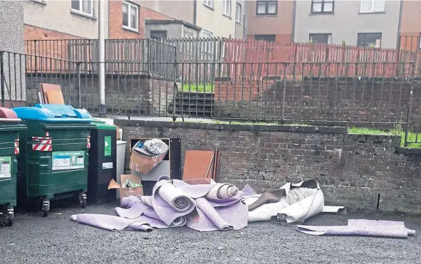  ??  ?? Furniture, rolls of carpet and other waste has been dumped next to bins near Leith Walk in Dundee.