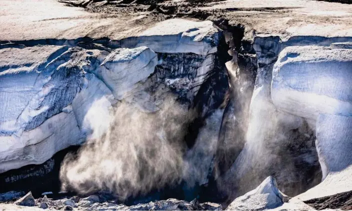  ?? Photograph: Kerem Yücel/AFP/Getty Images ?? Meltwater flows from the ice sheet into the Baffin Bay near Pituffik in northern Greenland.