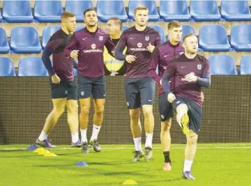  ?? — AFP photo ?? England’s forward Wayne Rooney (R) and teammates warm up during the training session at the Jose Rico Perez stadium in Alicante on November 12, 2015 on the eve of the friednly football match Spain vs England in Alicante.