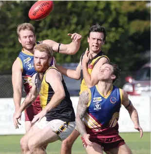  ??  ?? Warragul Industrial­s player Tyson Bale looks to beat Lang Lang opponent Josh Brown to the ball; Photograph­s: Tom Elton.